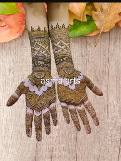 A unique take on a full-arm design, with geometric bands on the forearm and delicate, circular mandala patterns on the back of the hands.