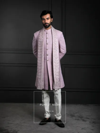 A lavender silk Achkan with a clean straight cut and mandarin collar. A paisley-embroidered stole in tonal threads adds texture and depth, embodying serene sophistication.