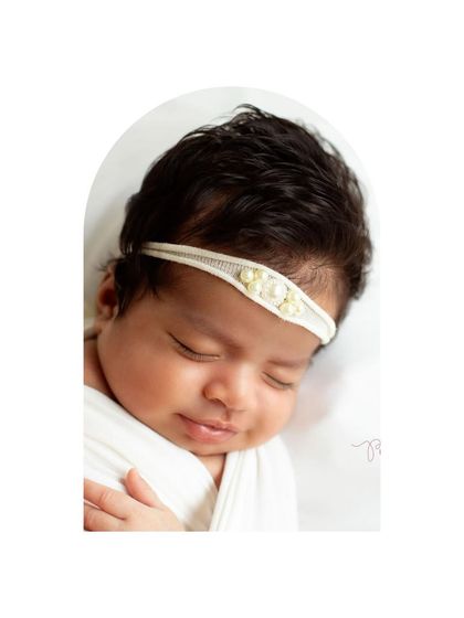 A close-up of this beautiful newborn girl. Her thick hair and peaceful smile are just precious. Even in a family session, I make sure to get stunning solo portraits of the baby.