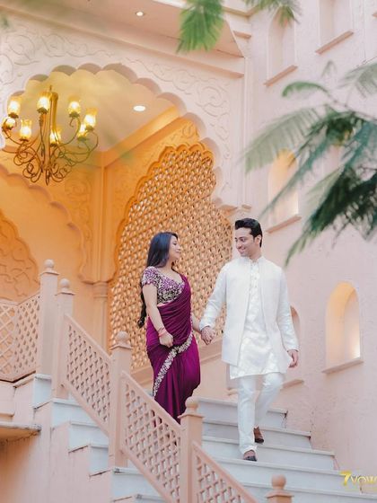 An elegant walking shot at a beautiful location. The makeup is sophisticated and timeless, matching her beautiful saree.