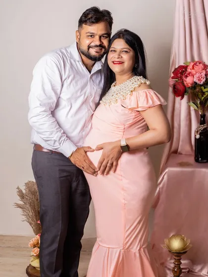 A classic pose filled with so much love. The couple forms a heart with their hands on the baby bump, a simple and sweet gesture that I love to capture. The soft pink tones of the dress and backdrop add to the gentle feel.