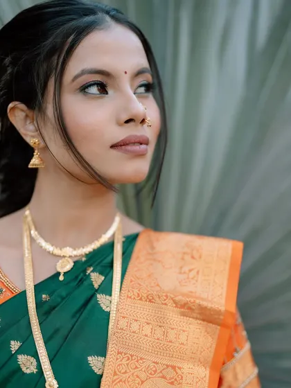 A profile shot of the bride, showing off her elegant hairstyle and the subtle glow of her makeup.