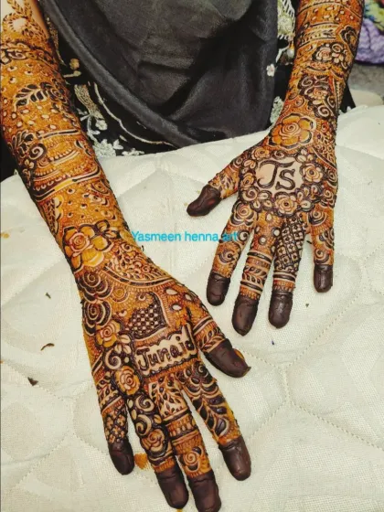 Saba's engagement mehndi, featuring the couple's initials 'JS' and the groom's name 'Junaid' in the design.