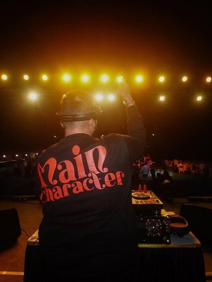 Rocking my 'Main Character' shirt because on stage, that's the energy I bring. This is my view of the crowd from the DJ console.