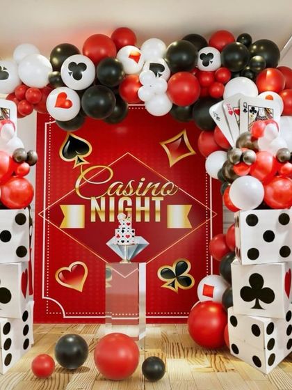 Roll the dice and get the party started. This all-in-one Casino Night backdrop is perfect for a high-energy party, featuring a red backdrop, dice columns, and a balloon arch with card suit details.