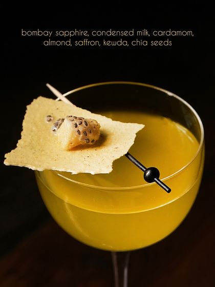 Our Kulfi cocktail, featuring Bombay Sapphire gin, is clarified with milk to achieve a silky texture. The familiar notes of cardamom, saffron, kewda, and almond are layered to create a drink that is both a dessert and a cocktail.
