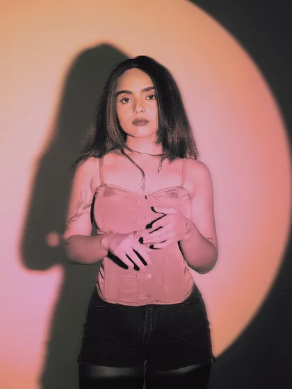 A portrait in a pink-lit spotlight. This image, used to promote a closing set, captures the focused, artistic energy I bring when I'm tasked with taking the crowd on a final journey.