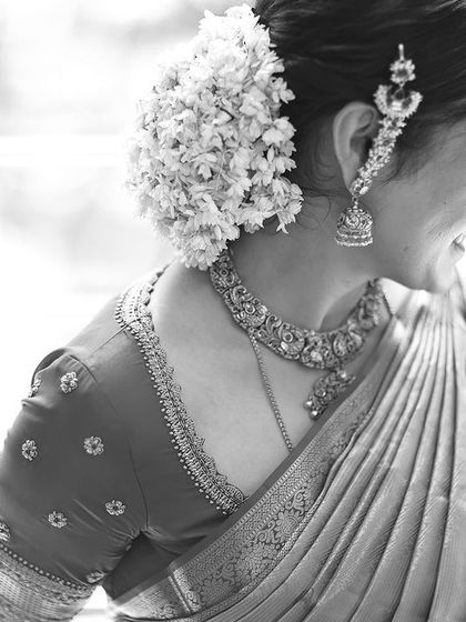 A beautiful black and white shot of a bride, highlighting the texture of her saree and the simple butti embroidery on her blouse.