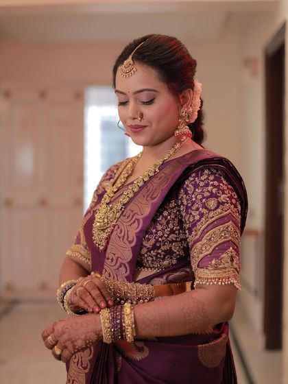 A close-up of the intricate embroidery on Madhu's blouse, which complements her saree perfectly.
