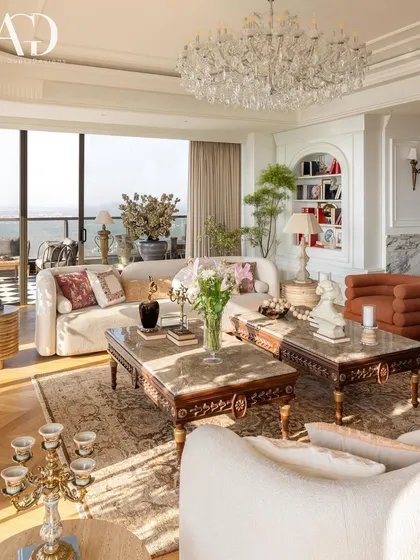 My approach to living spaces involves a rich layering of textures, patterns, and eras. Here, antique furniture, opulent sofas, and crystal chandeliers are juxtaposed with contemporary pieces, creating a room that feels like a lived-in celebration of personal history and timeless style.
