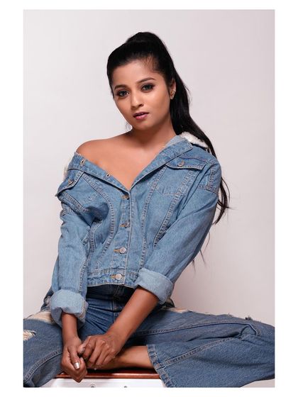 A full-body shot of the same denim-on-denim outfit. The seated pose is casual and relatable, perfect for a youth-focused fashion brand.