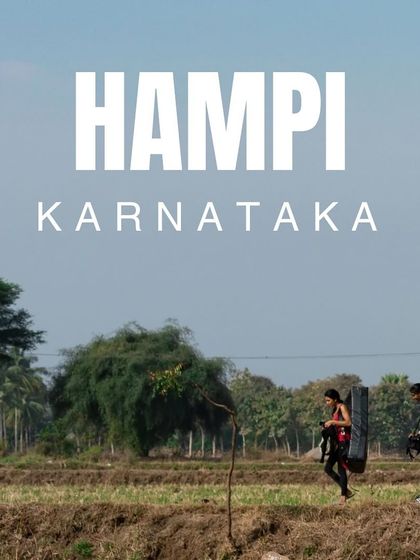 The journey is part of the adventure. Here, two of our crew walk through the paddy fields of Hampi, Karnataka, carrying crash pads on their way to the boulders.