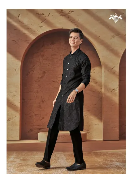 Timeless charm tailored to perfection. This classic black kurta with a subtle texture and a modern, rounded hem is an essential piece for the modern man's ethnic wardrobe.