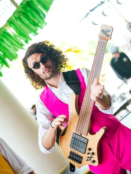 A musician from the live band at the Coachella Haldi, adding to the cool, festival vibe of the event.