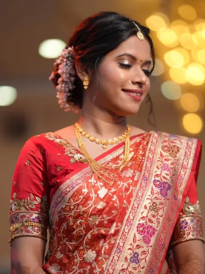 The color of love and new beginnings. This bride looks radiant in her red silk saree, draped in a classic style for her reception.