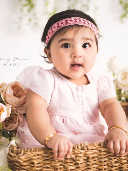 A basket of cuteness! Using props like this wicker basket adds a lovely texture and dimension to sitter portraits, while keeping the baby safe and supported.