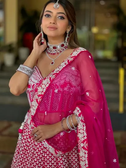 A vision in pink for a sangeet or reception. This soft-glam look combines a romantic pink palette with glowing skin and beautifully highlighted features, ensuring you look and feel like the star of the evening.