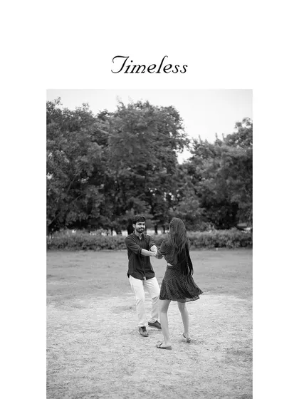A classic black and white photo of a couple dancing in a park. This timeless style focuses on the emotion and movement of the moment.