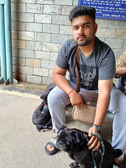 A handsome black pug waiting patiently with his dad. We make sure we have all our ducks in a row to make the AQCS visit as quick as possible.