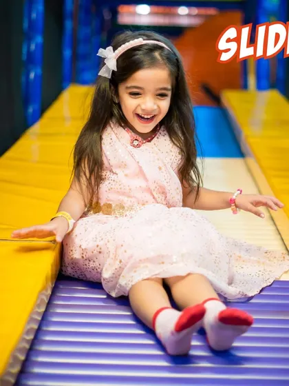 A joyful slide down our yellow roller slide. The unique design offers a fun, bumpy ride that kids love.