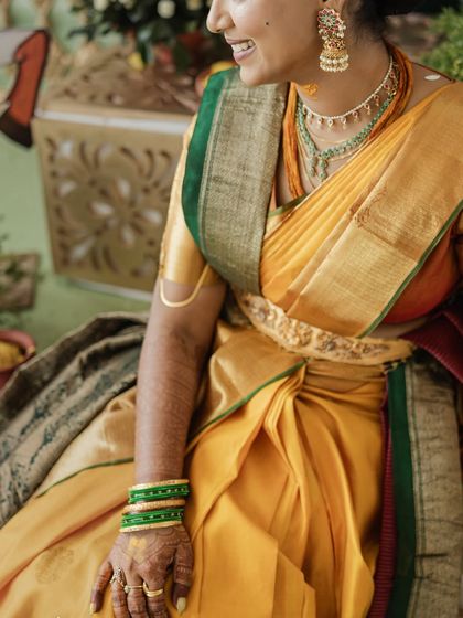 A close-up of the layered Kanjeevaram sarees and the intricate temple jewellery, a key part of the South Indian bridal look.