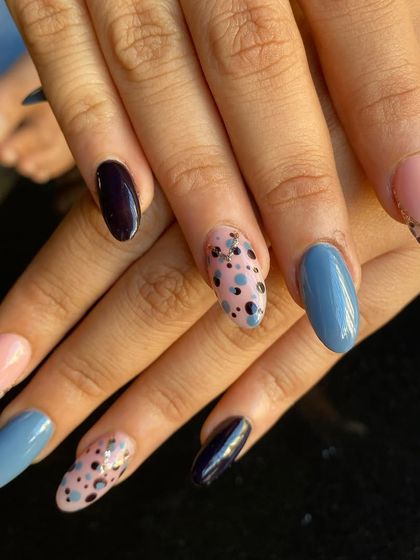A fun and eclectic mix-and-match set. This client chose a combination of solid blue, solid black, and a speckled pattern with a glittery French tip. I love it when you get creative with your sets.