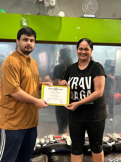 Recognizing a student's achievement. Her hard work and commitment to training have paid off.