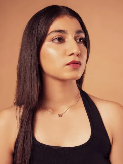 A profile shot that highlights the model's features and the soft lighting on her skin.