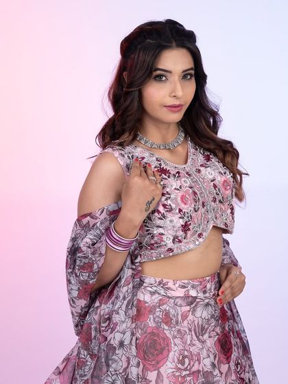 A close-up of this gorgeous floral print lehenga. The delicate embroidery on the blouse and the soft pastel tones make it a romantic and feminine choice for any celebration.