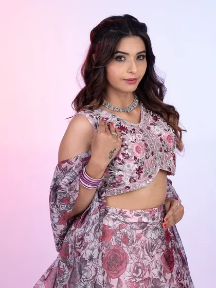 A close-up of this gorgeous floral print lehenga. The delicate embroidery on the blouse and the soft pastel tones make it a romantic and feminine choice for any celebration.