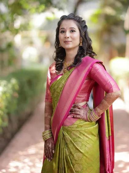 A beautiful look in a parrot green and pink saree. The makeup is versatile, complementing a range of colourful traditional outfits.