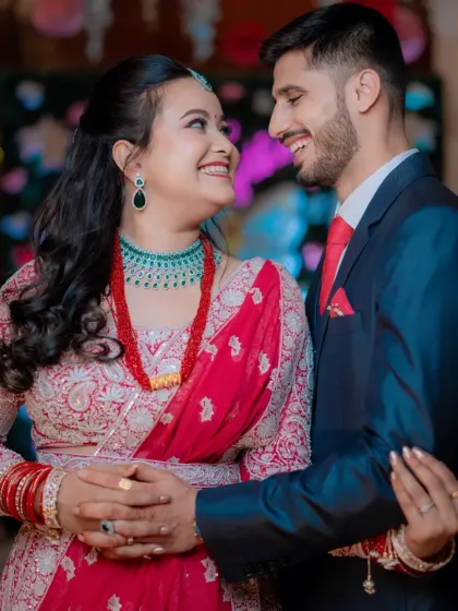 The couple sharing a smile, with the bride's radiant makeup shining through.