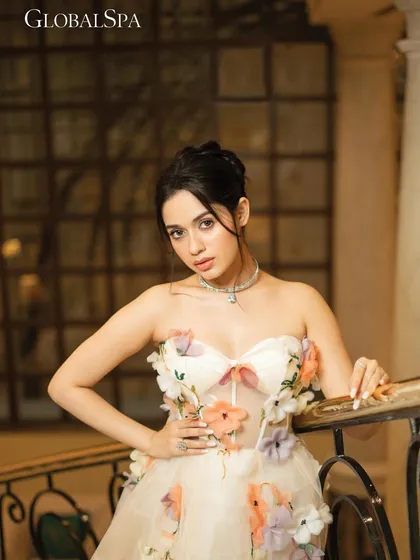 A tighter shot from the staircase set, highlighting the floral details on the gown and the delicate jewelry. The composition is framed to feel personal and engaging.