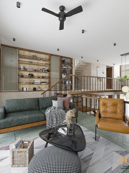 The mezzanine family lounge, featuring a large shoe rack with jaali work and a comfortable green sofa.