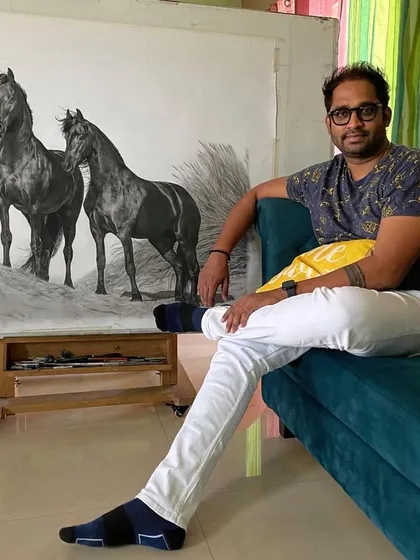 Relaxing in my studio with the large 5 by 3 foot 'Harmony' horse drawing in the background. This is where I spend countless hours bringing my visions to life.