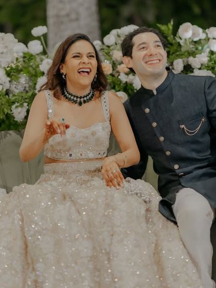 Candid laughter on the Sangeet stage. We create a comfortable and fun atmosphere where you can relax and genuinely enjoy the performances and speeches.