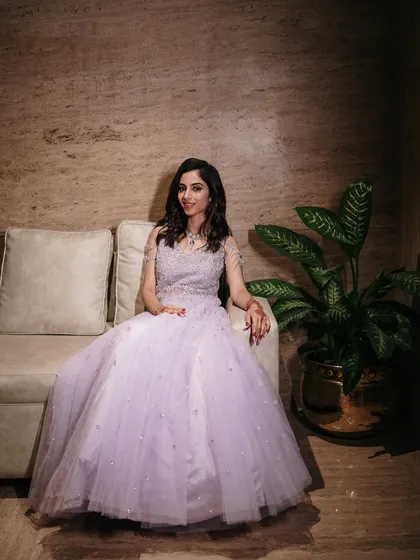 A stunning full-length portrait of the bride-to-be in her fairytale lavender gown, seated elegantly before her engagement ceremony.