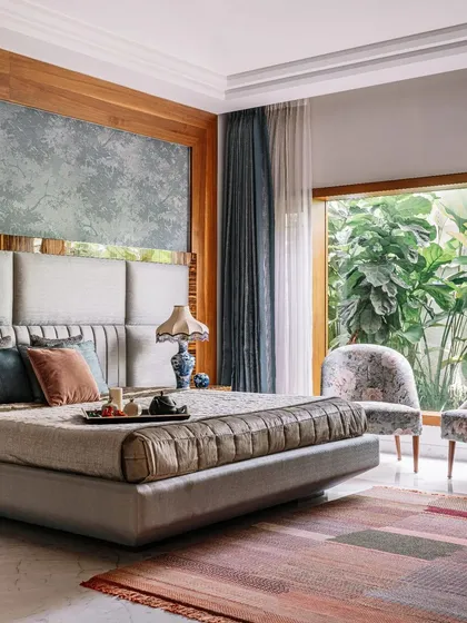 I believe a master bedroom should be a peaceful retreat. Here, we framed the garden view with a large window, making nature the primary artwork. The soft textures, custom headboard, and calm color palette come together to create a space of timeless elegance and comfort.