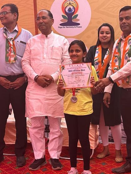 Another one of my students being awarded for her excellent performance in a yoga competition. We train to compete and to win.