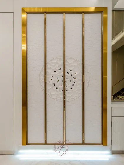 The mandir doors closed, showcasing the intricate, custom-designed 3D pattern on the exterior. The design is both a beautiful decorative element and a respectful enclosure for the sacred space within.