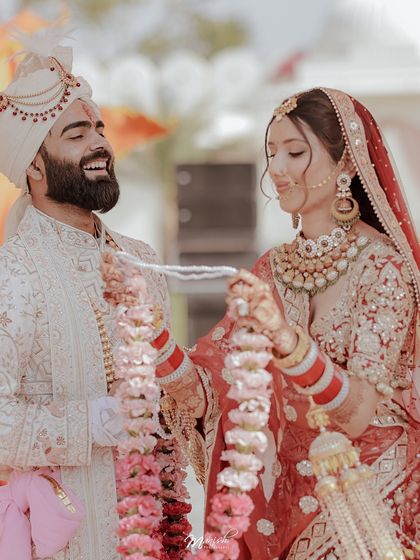 A beautiful, happy moment during the Varmala ceremony, capturing the couple's excitement and joy.