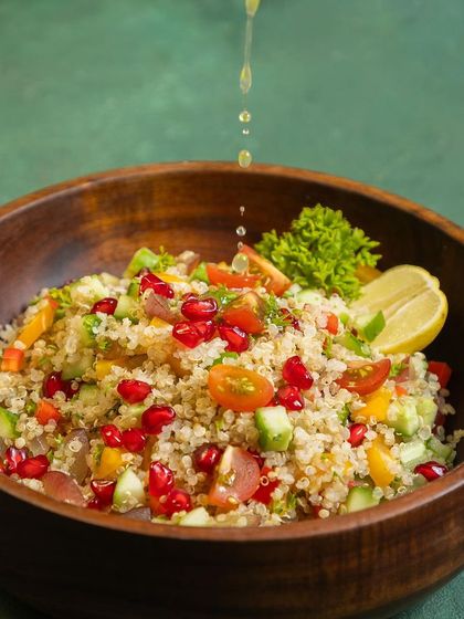 Our quinoa salad is a customer favorite. It's a complete protein source, tossed with fresh vegetables and pomegranate seeds for a burst of flavor and antioxidants. A light squeeze of lemon makes it perfect.