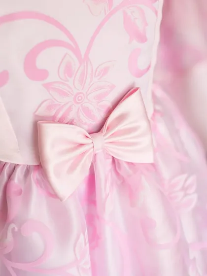 It's all in the details. This close-up shows the soft satin bow and delicate floral jacquard fabric that make my dresses so special. I believe these little touches of craftsmanship are what transform a simple frock into a cherished piece.