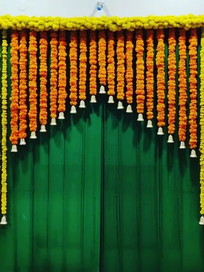 A simple yet beautiful way to decorate for a festival. This marigold toran with bells instantly adds a traditional and festive feel to any space.