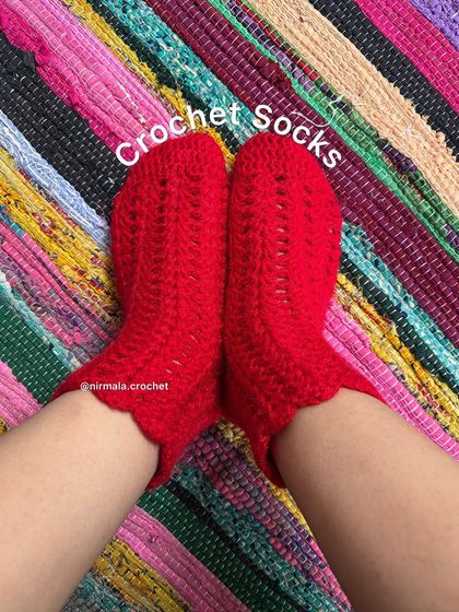 A top-down view of our red lace crochet socks, showing the pretty scalloped cuff detail.