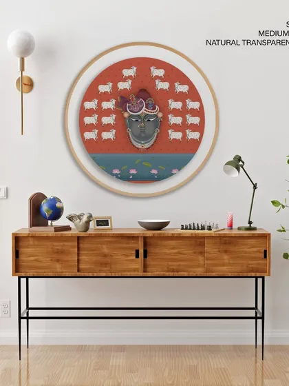 This captivating circular portrait of Shrinathji offers a modern take on traditional Pichwai art. Shown here in a 47-inch natural transparent frame, it blends spiritual significance with contemporary design, making it a unique centerpiece for an entryway or living area.
