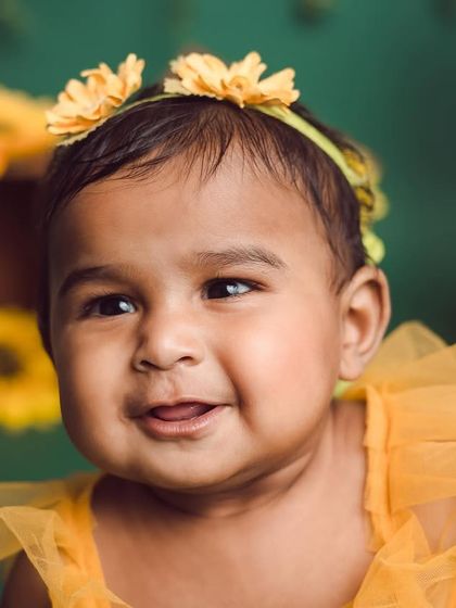 Our little sunflower. A close-up shot capturing a beautiful, happy expression during our popular sunflower-themed session.