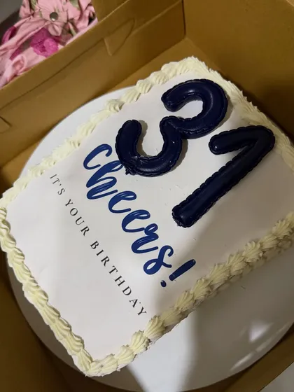 A simple and elegant birthday cake with a custom "Cheers! It's your birthday" message. Sometimes, a classic design is all you need to celebrate.
