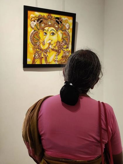 Another visitor viewing a fellow artist's Kerala mural style Ganesha at our group show.