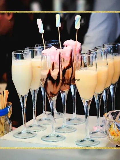Another view of our indulgent chocolate and milk-based shakes, served in elegant champagne flutes and garnished with marshmallows and cotton candy.